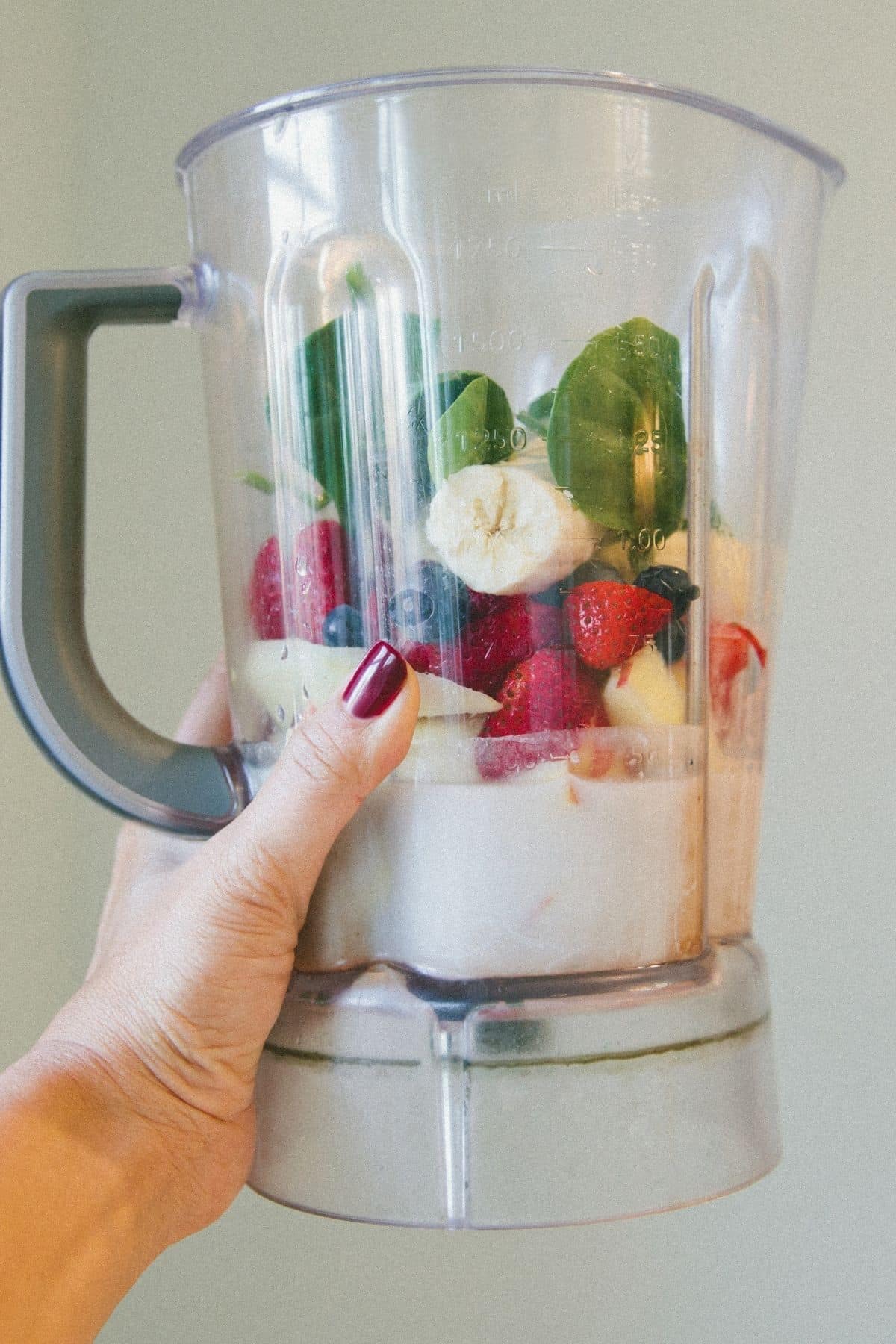 blender with fruit and greens