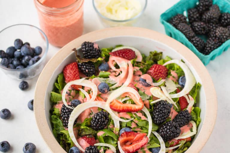 strawberry salad dressing on top of salad.