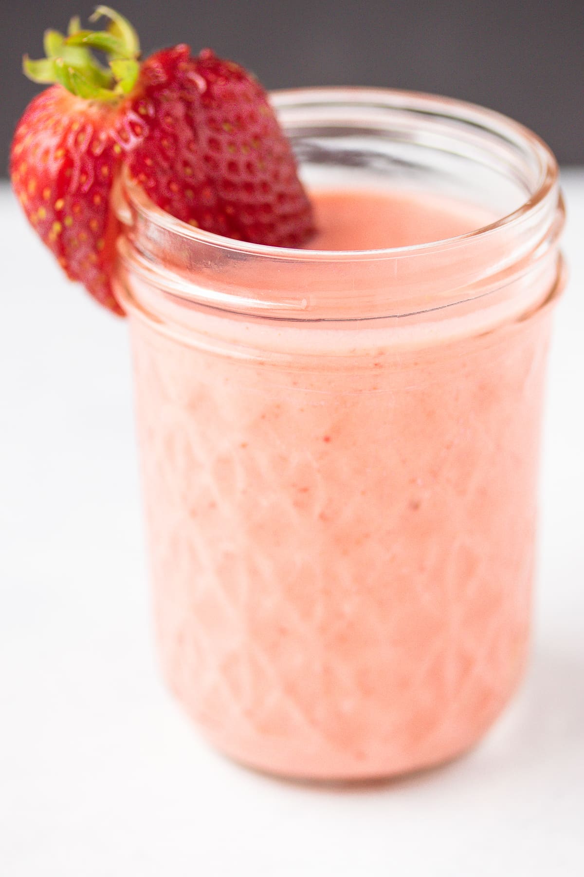 creamy strawberry dressing in a glass jar.
