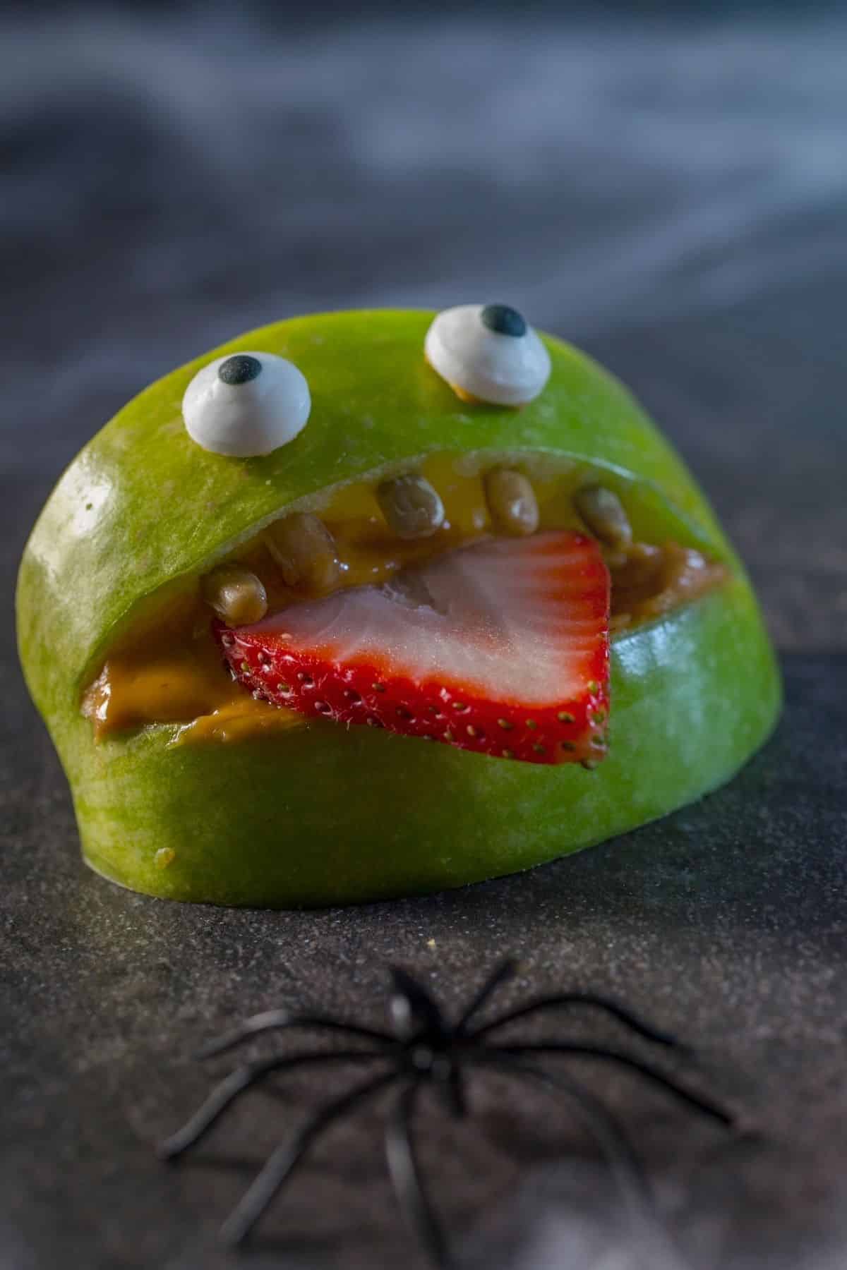 funny face made using an apple and strawberry.