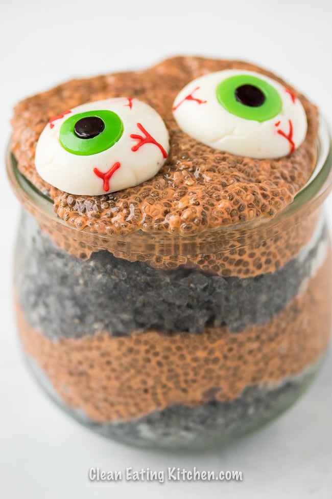 orange and black chia pudding with scary gummy eyes.