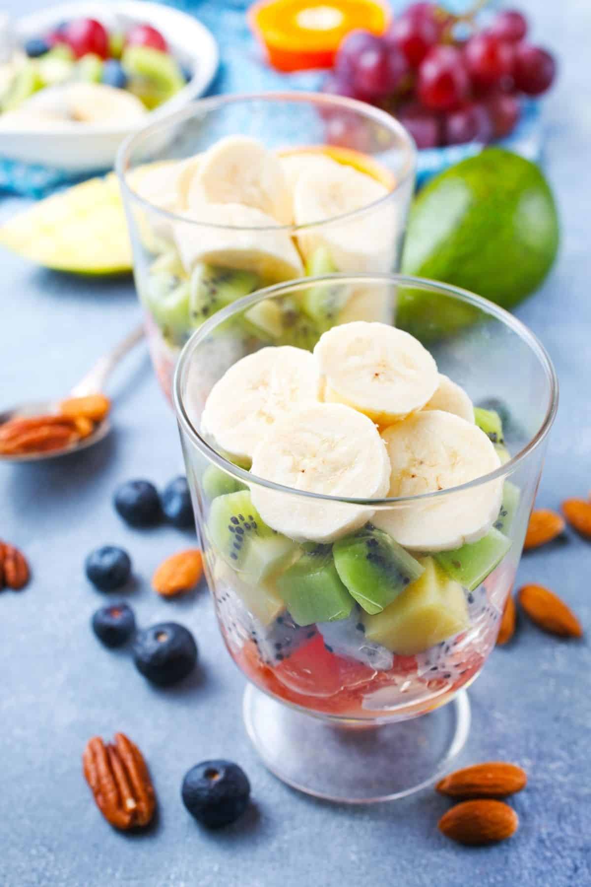 collection of fresh fruits in parfait glasses.
