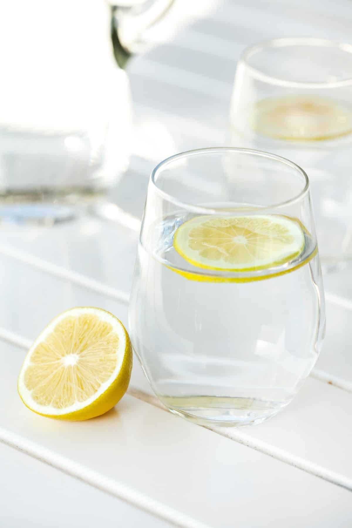 glass of water served with fresh lemon.