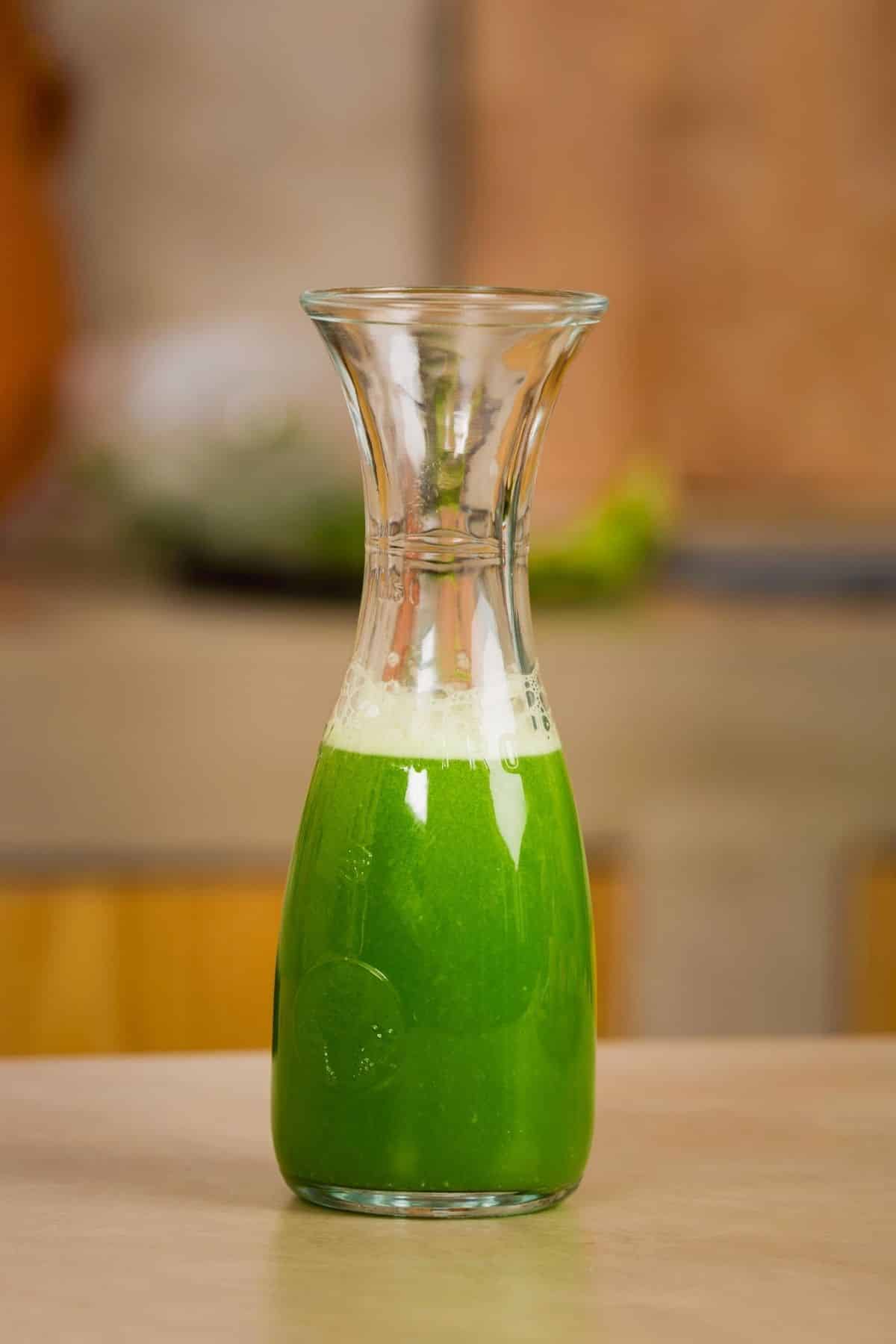 carafe of green juice on a table.