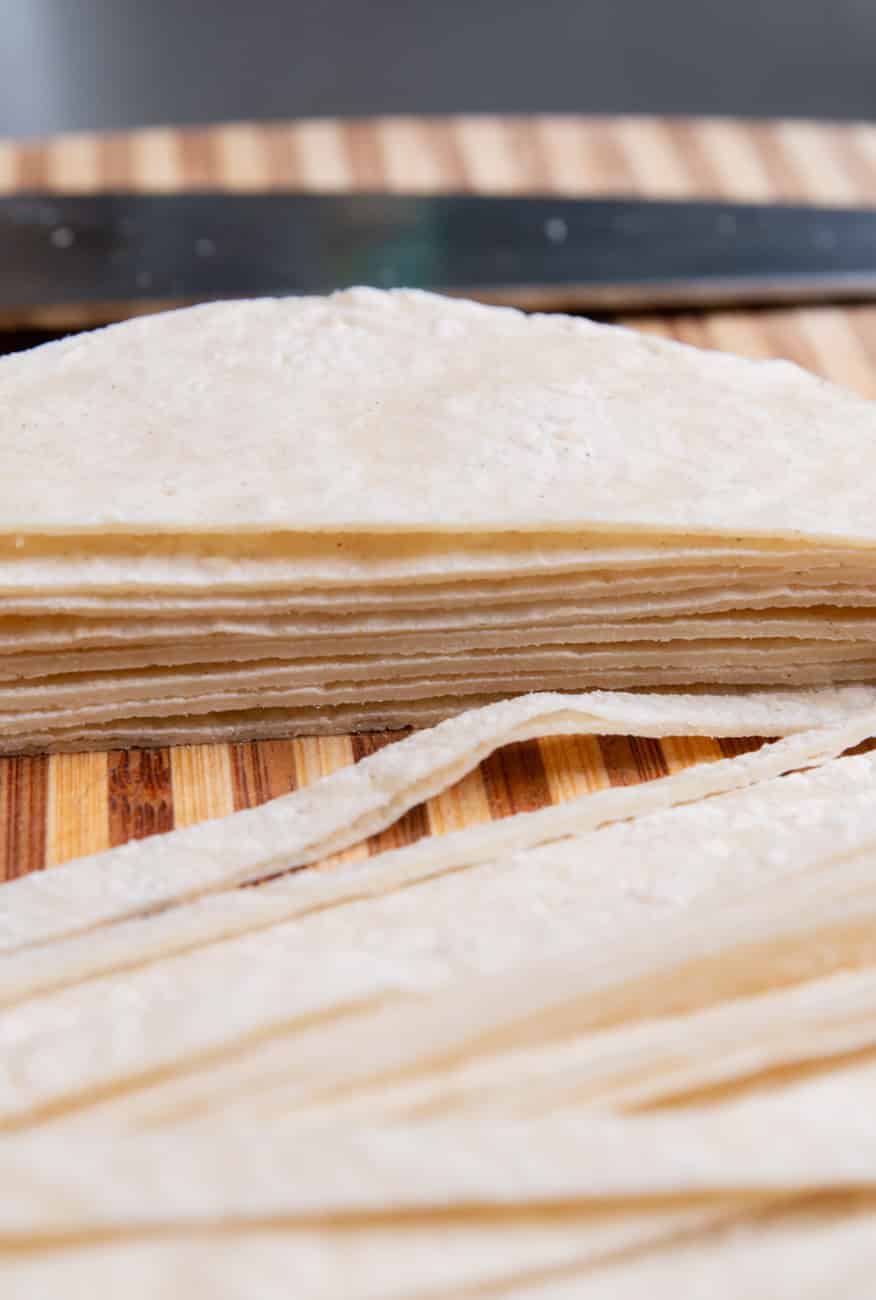 Stacked tortillas sliced and ready to be baked into crunchy strips.
