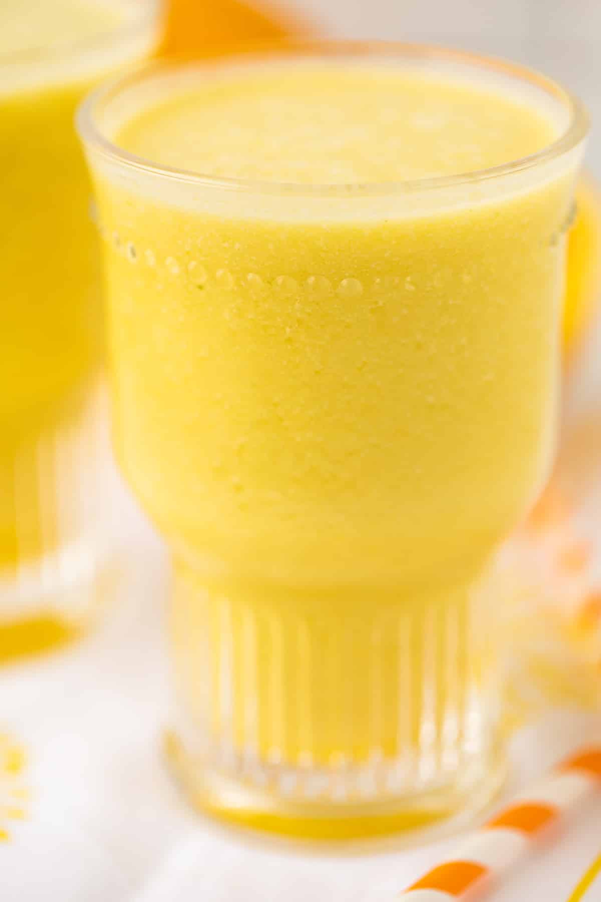 glass of orange pineapple smoothie.