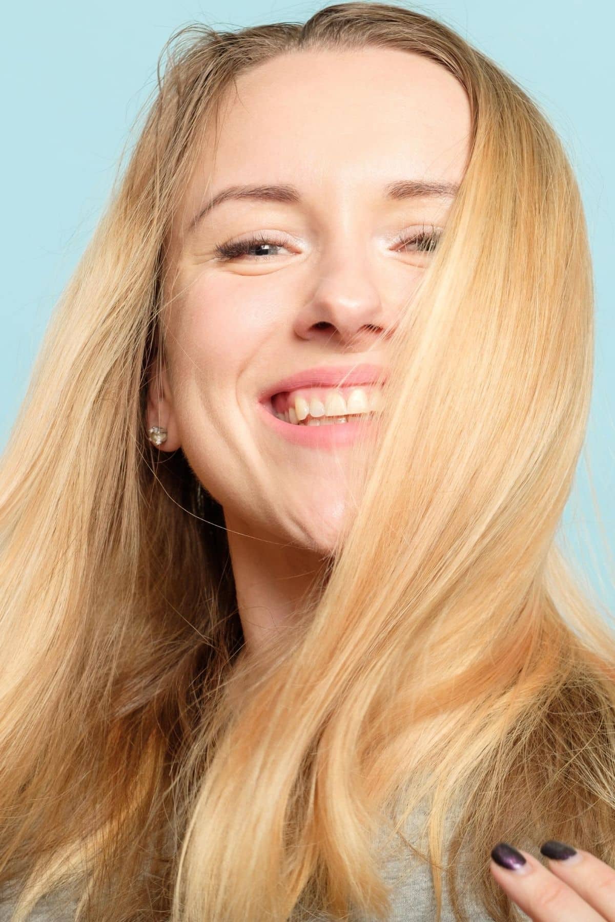 woman with long blond hair smiling at the camera.