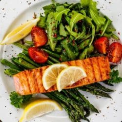 cooked salmon on a bed of steamed greens