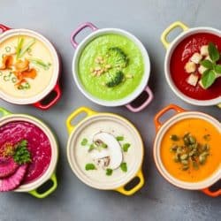 six difference soup recipes in colored bowls