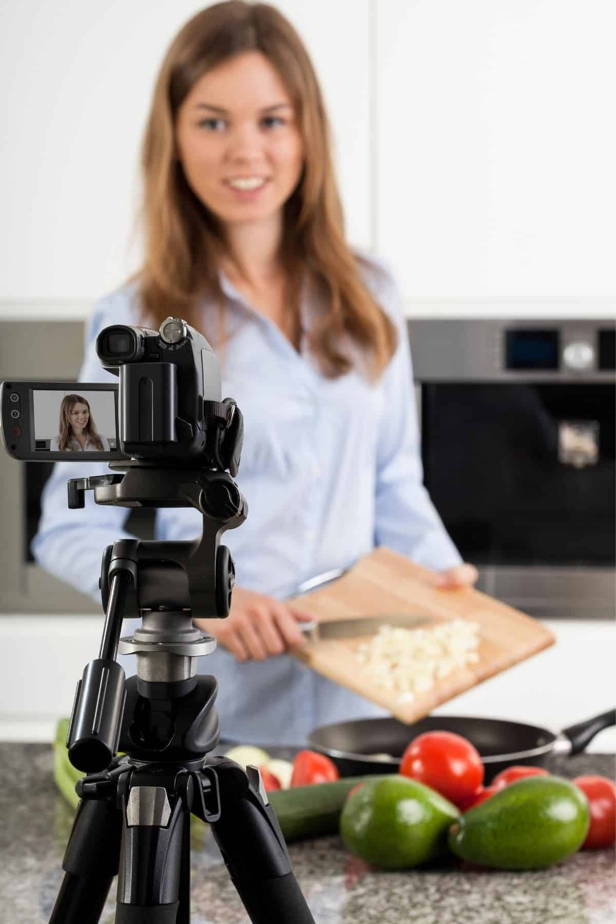woman cooking in front of a camera.