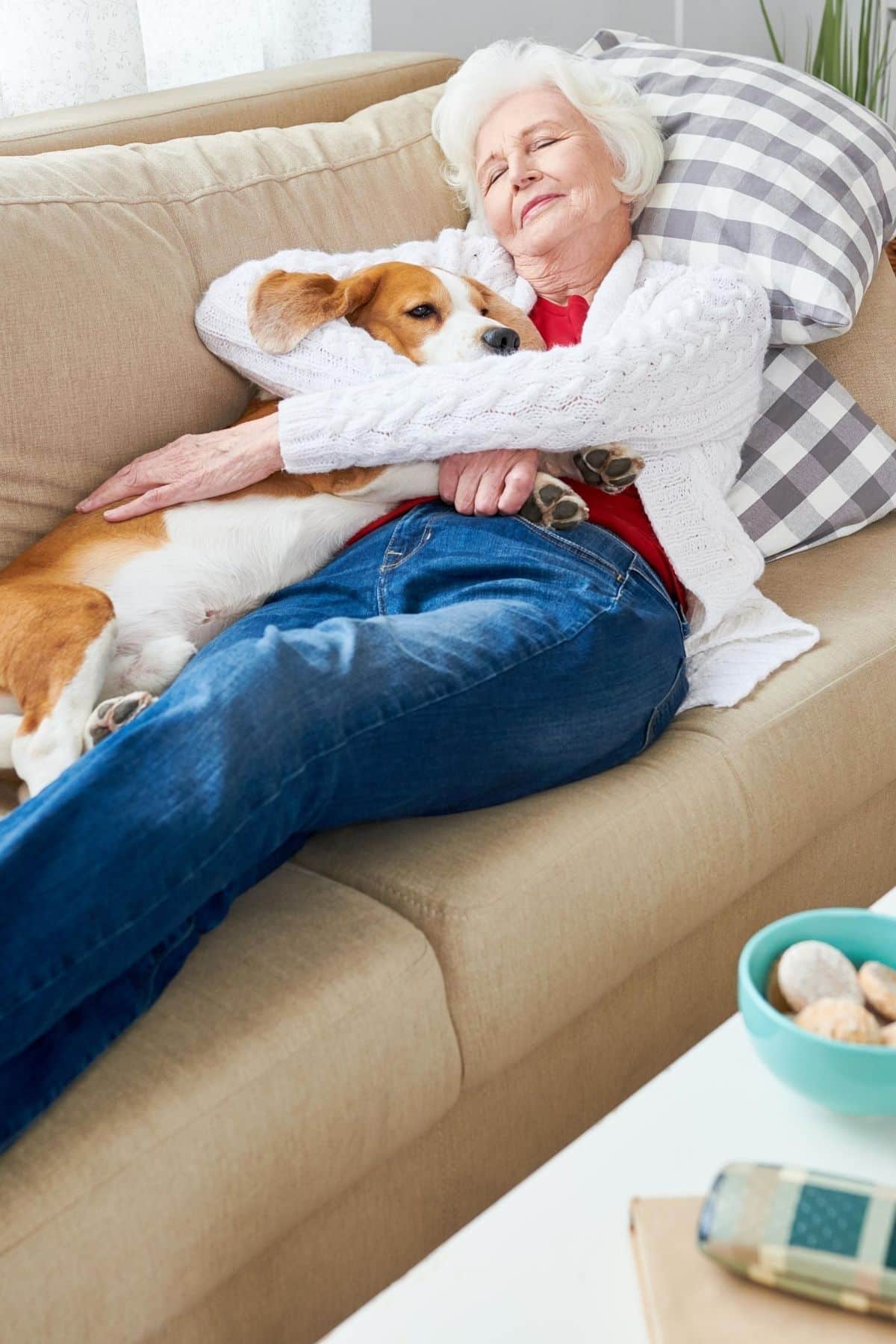 woman on couch napping with her dog.