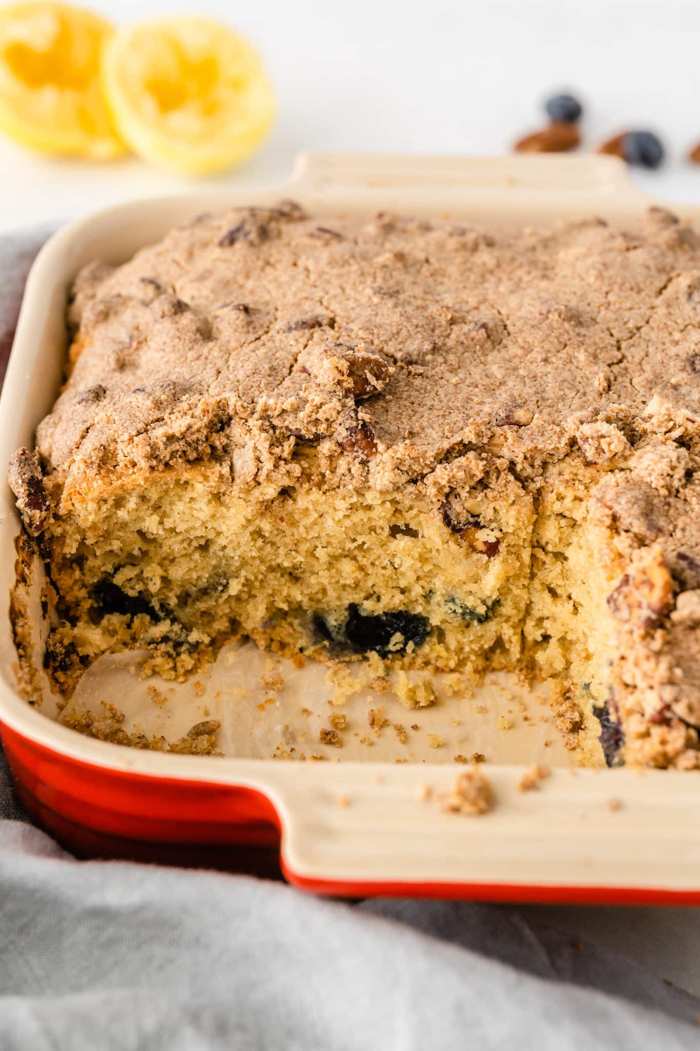 baked gluten free coffee cake with a slice cut out of it.