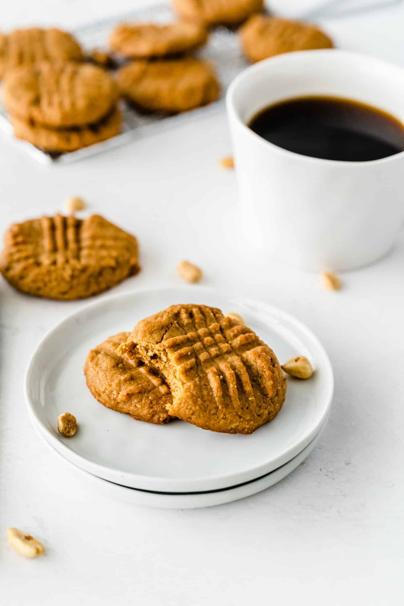 almond flour cookies on a plate with a cup of coffee