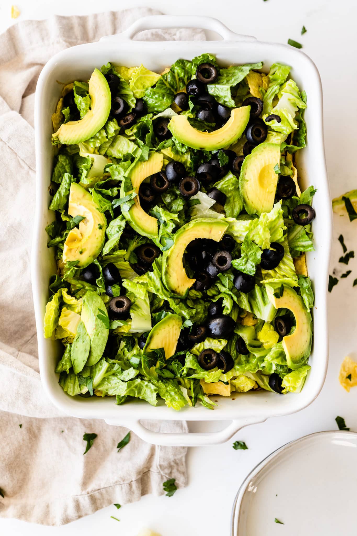 Vegan taco casserole with lettuce, olives, and avocado
