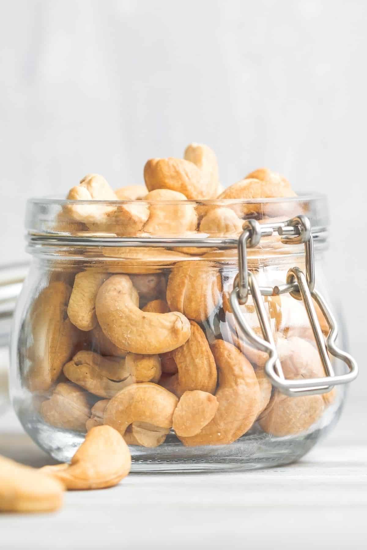 jar of cashew nuts on a tabletop.