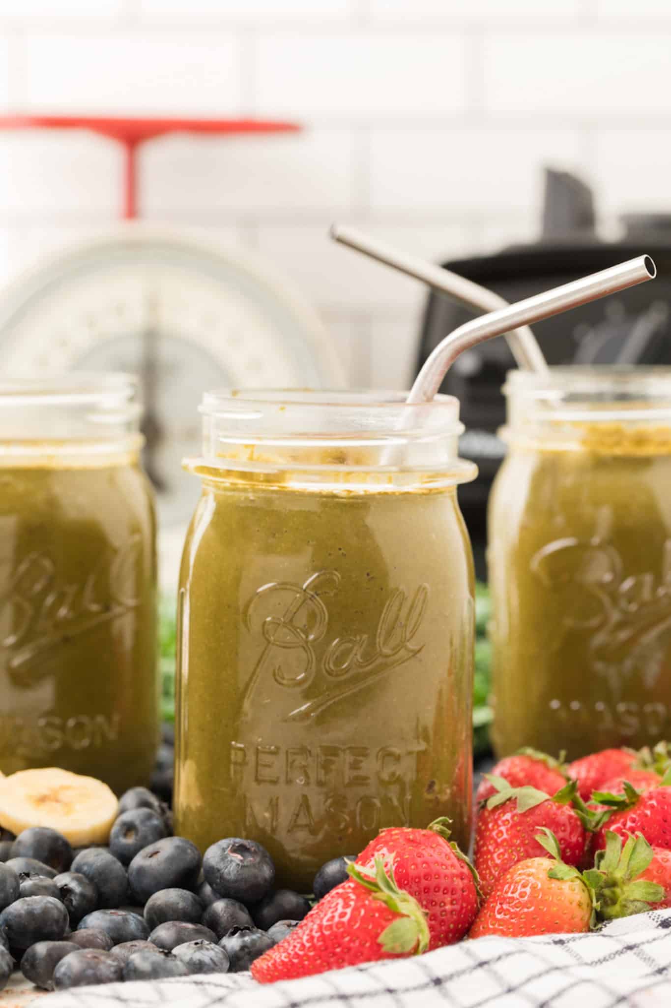 three servings of protein weight loss smoothie with blended kale in three jars.