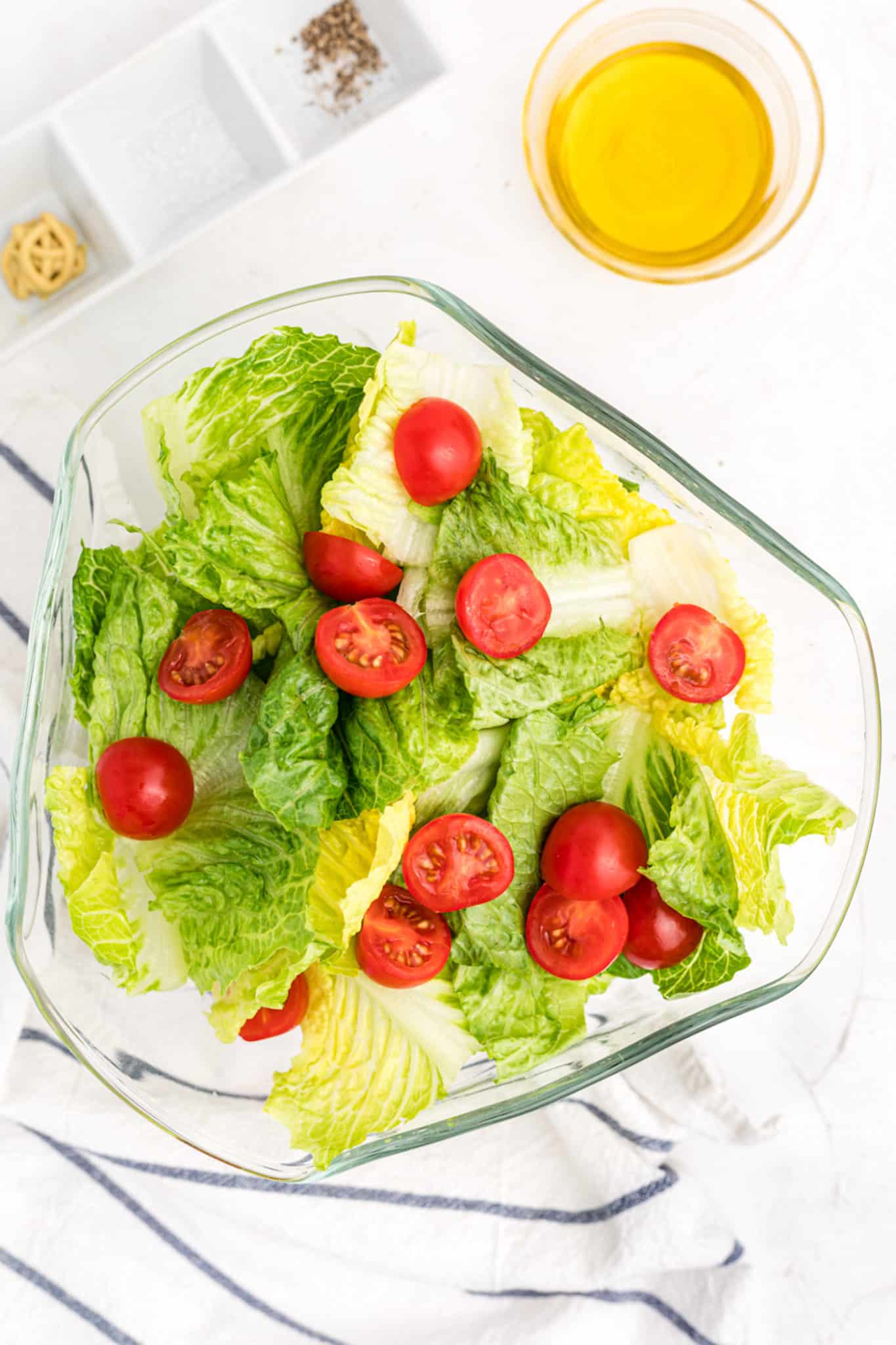 Romaine salad with a vinaigrette and tomatoes.