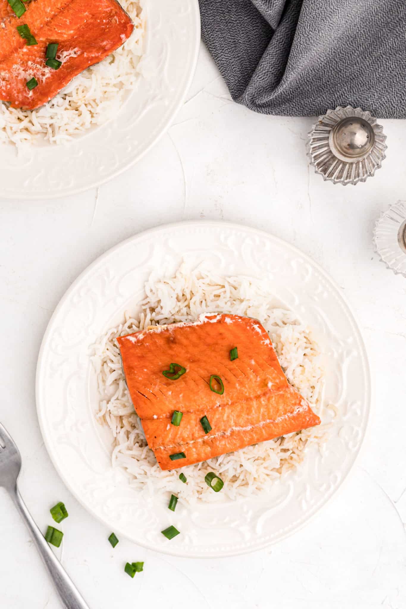 overhead photo with cooked salmon and rice on a serving plate.
