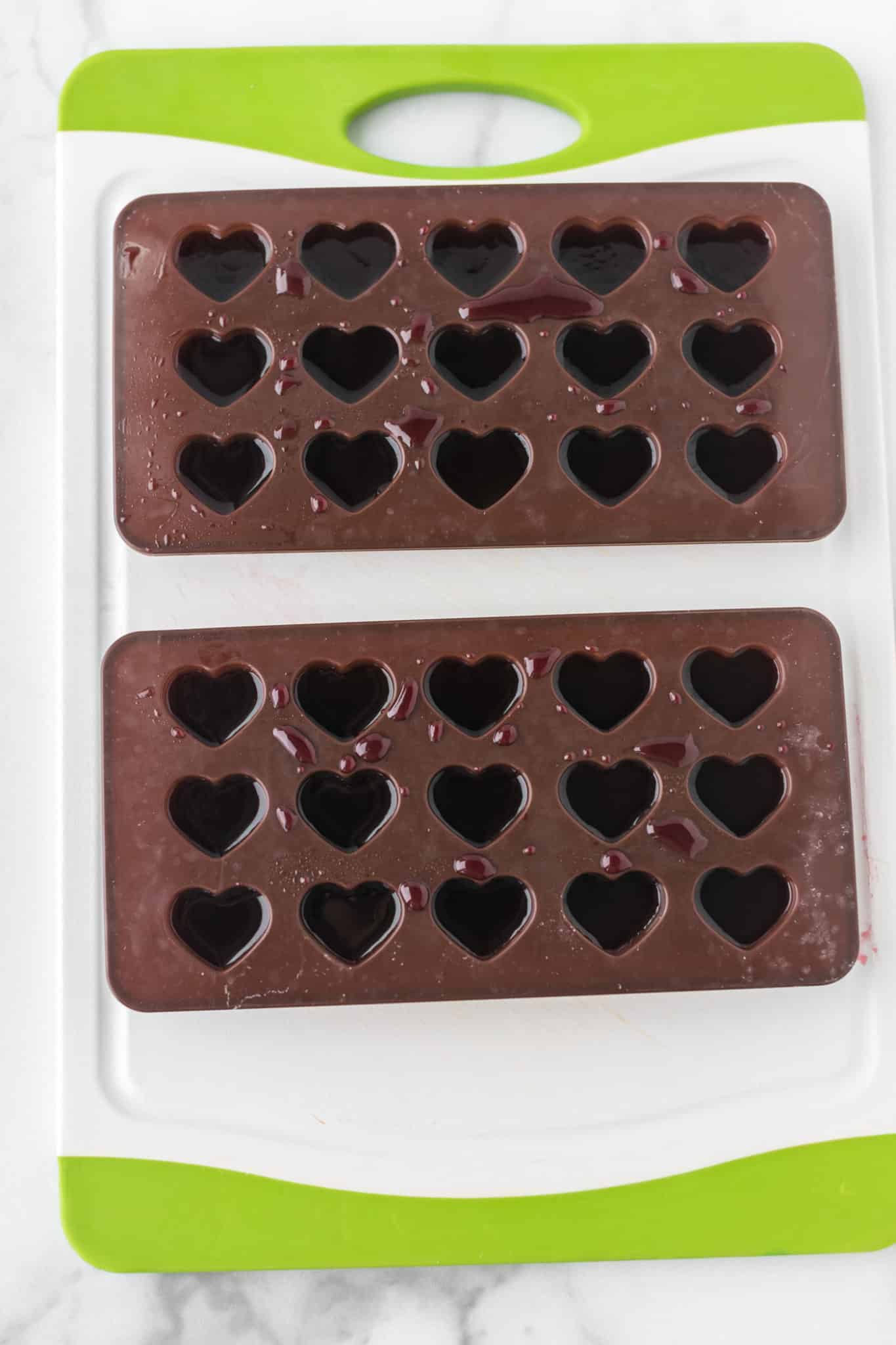gummy mixture in heart shaped molds