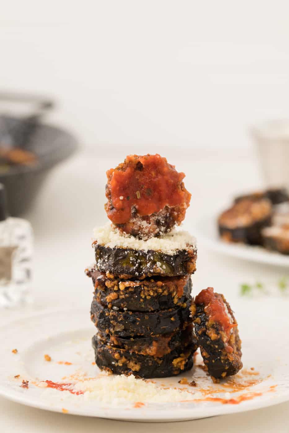 stack of cooked air fryer zucchini slices with marinara and parmesan