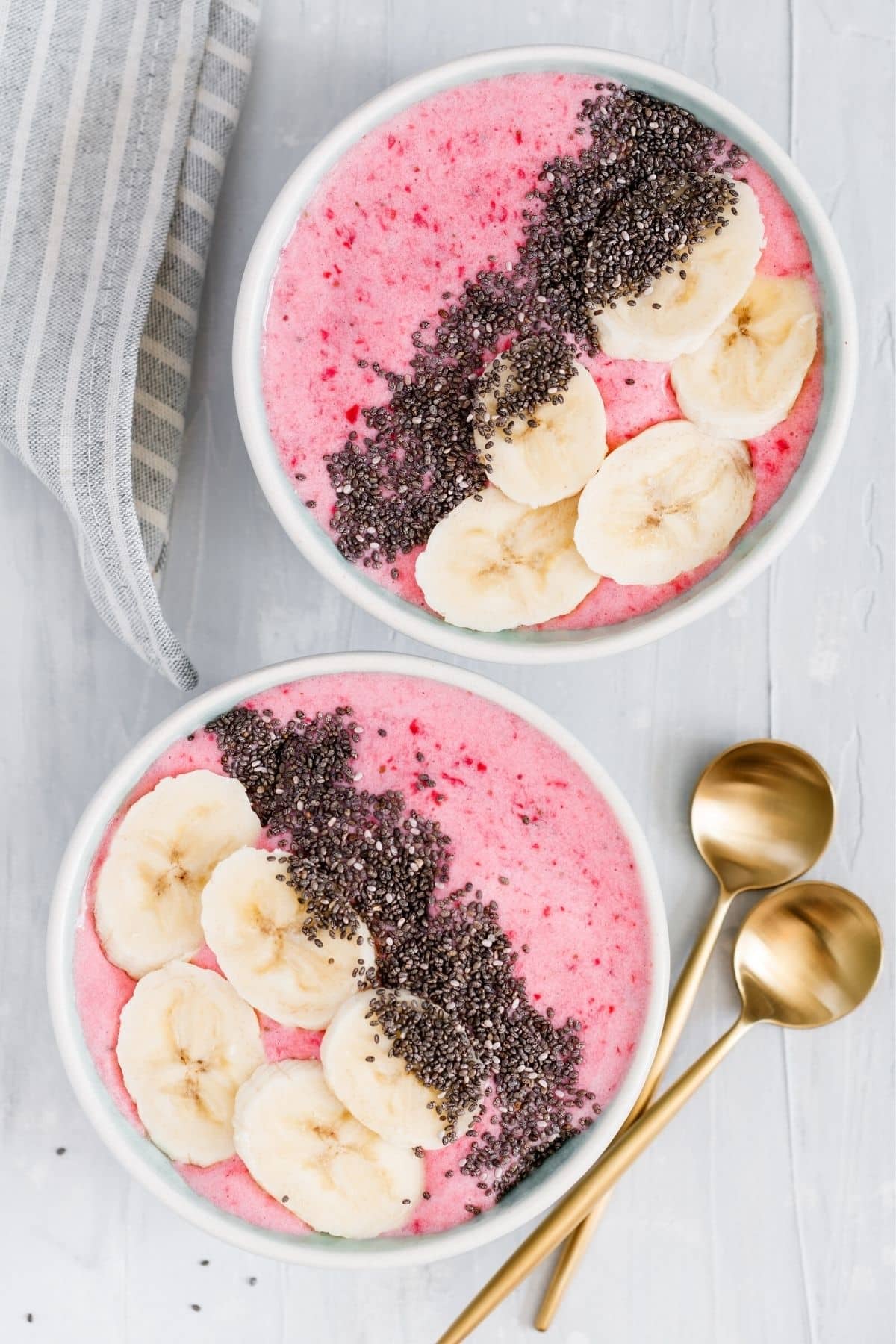 beautiful pink smoothie bowls with bananas and chia seeds.