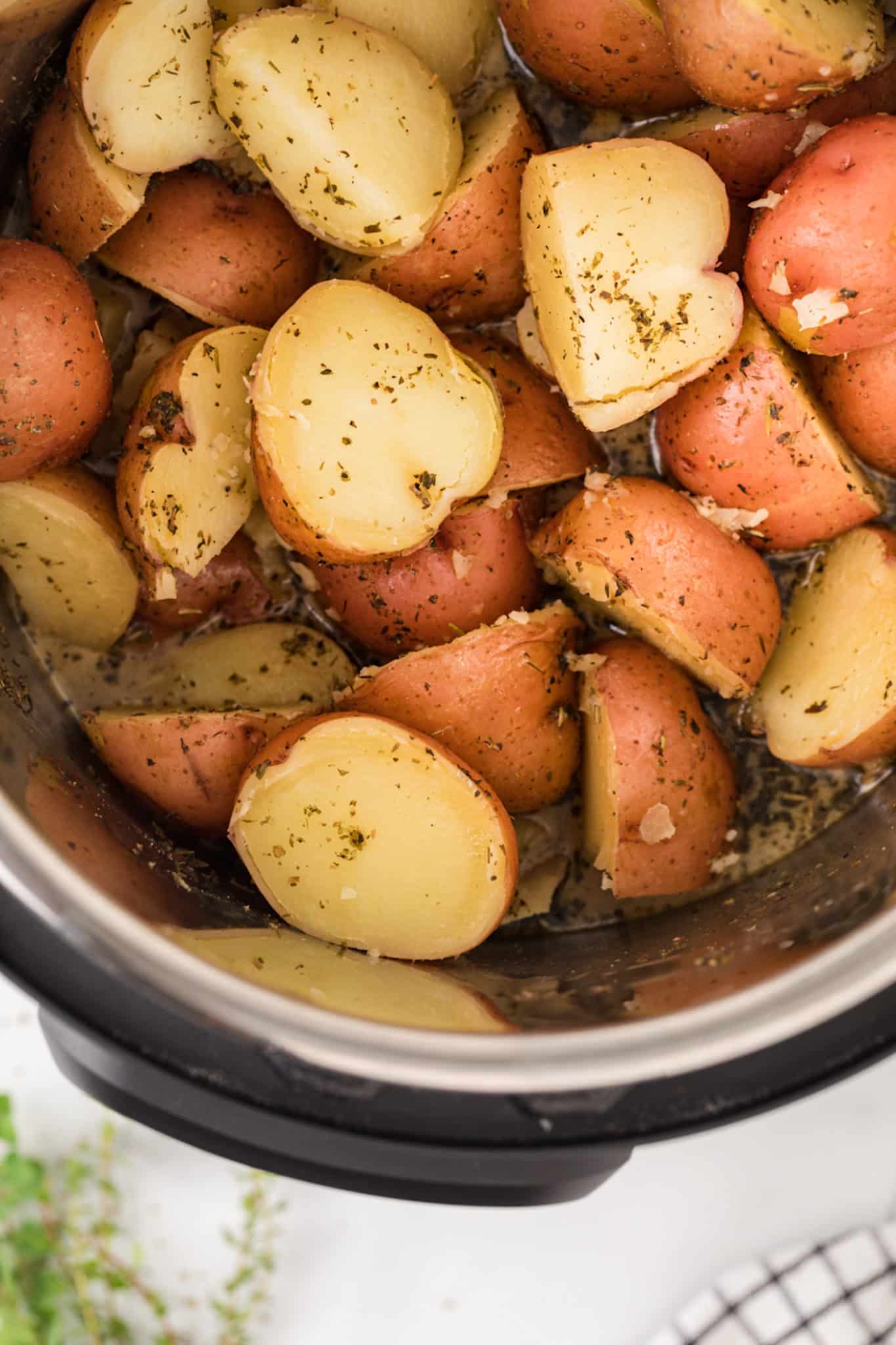 cooked red potatoes with seasonings inside instant pot.