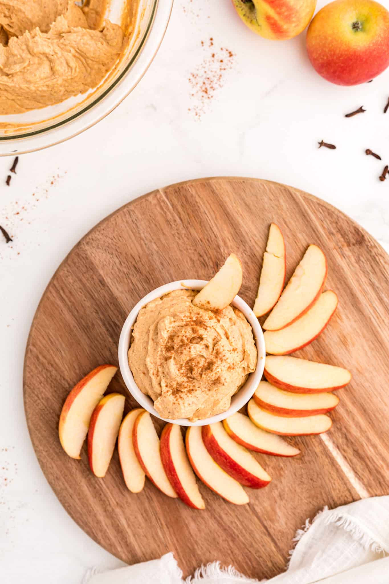 dip with apples on table.