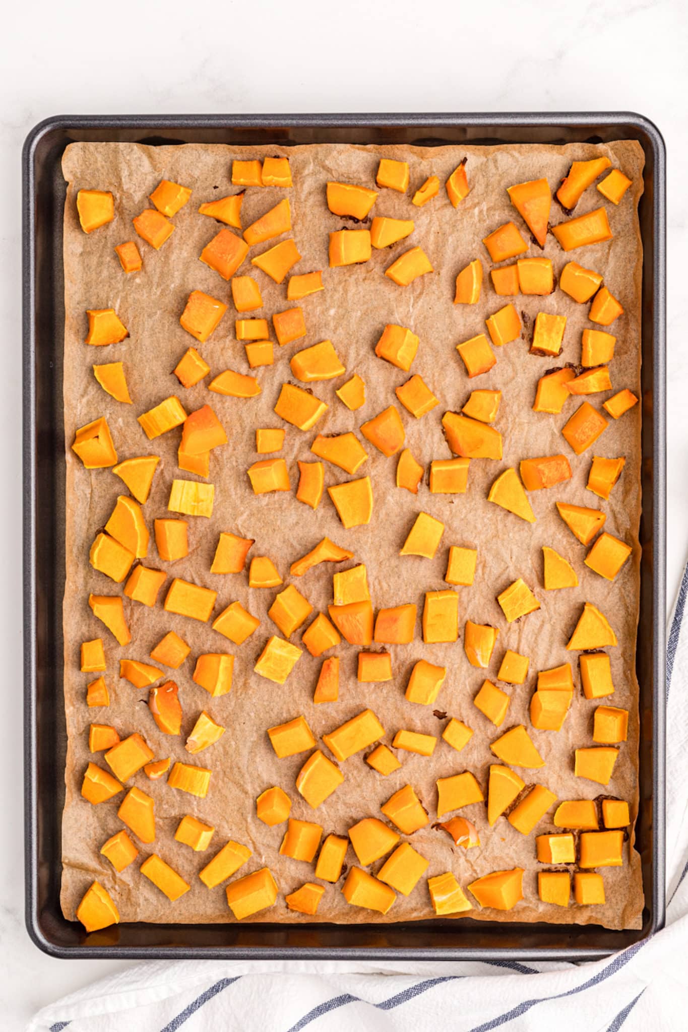 roasted squash pieces on a baking sheet.