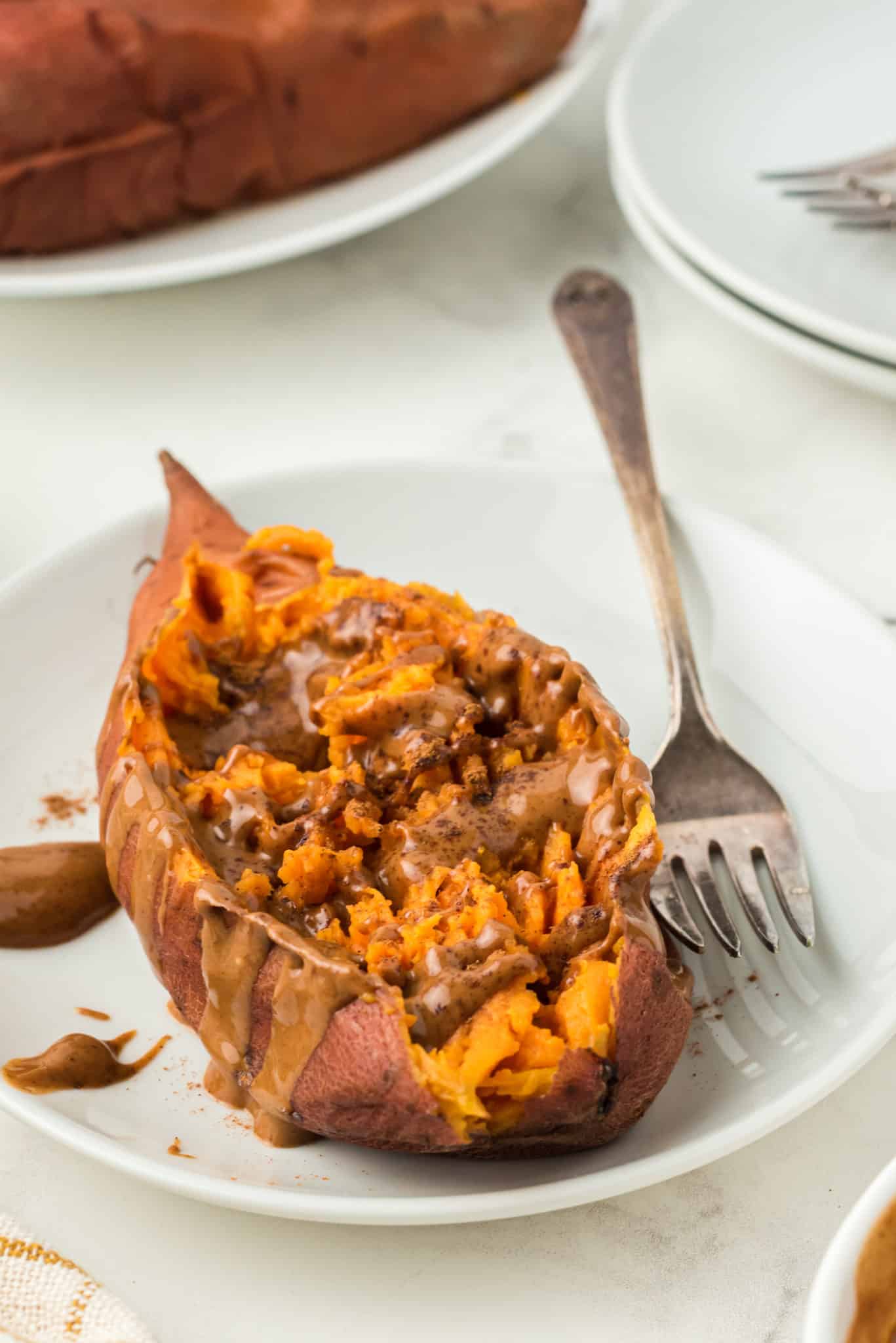 instant pot sweet potato topped with almond butter and cinnamon.