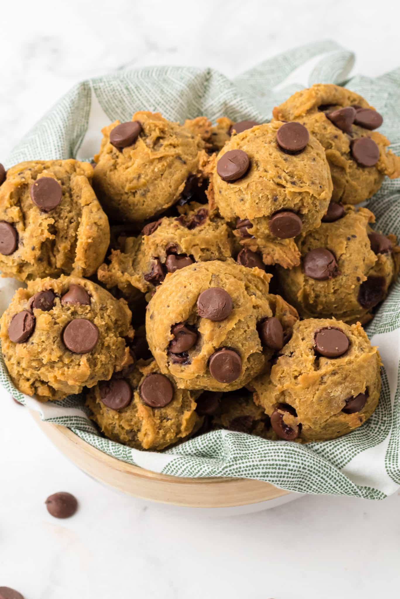 basket of vegan pumpkin chocolate chip cookies on a table