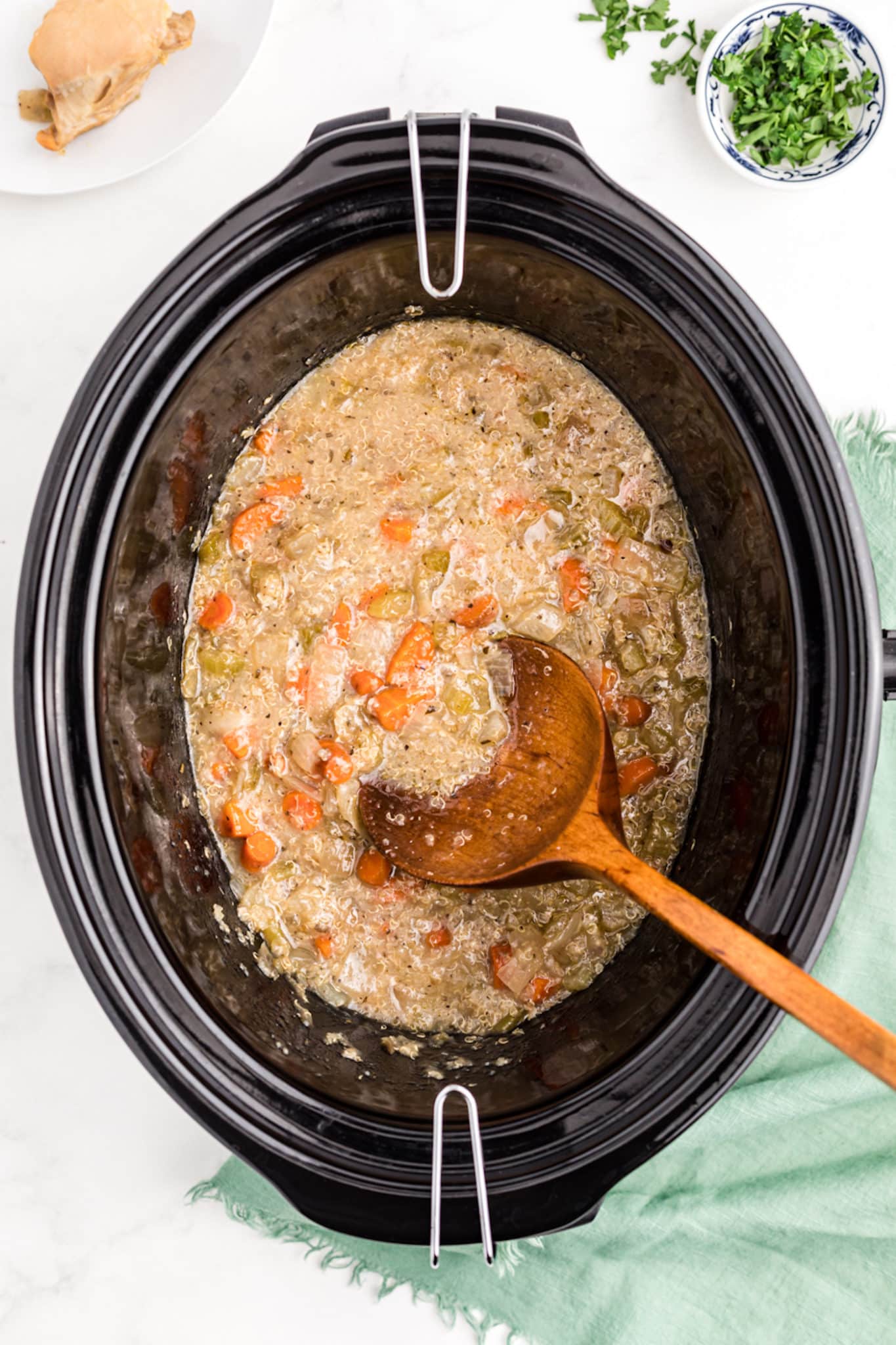 cooked quinoa and chicken stew inside a crockpot.
