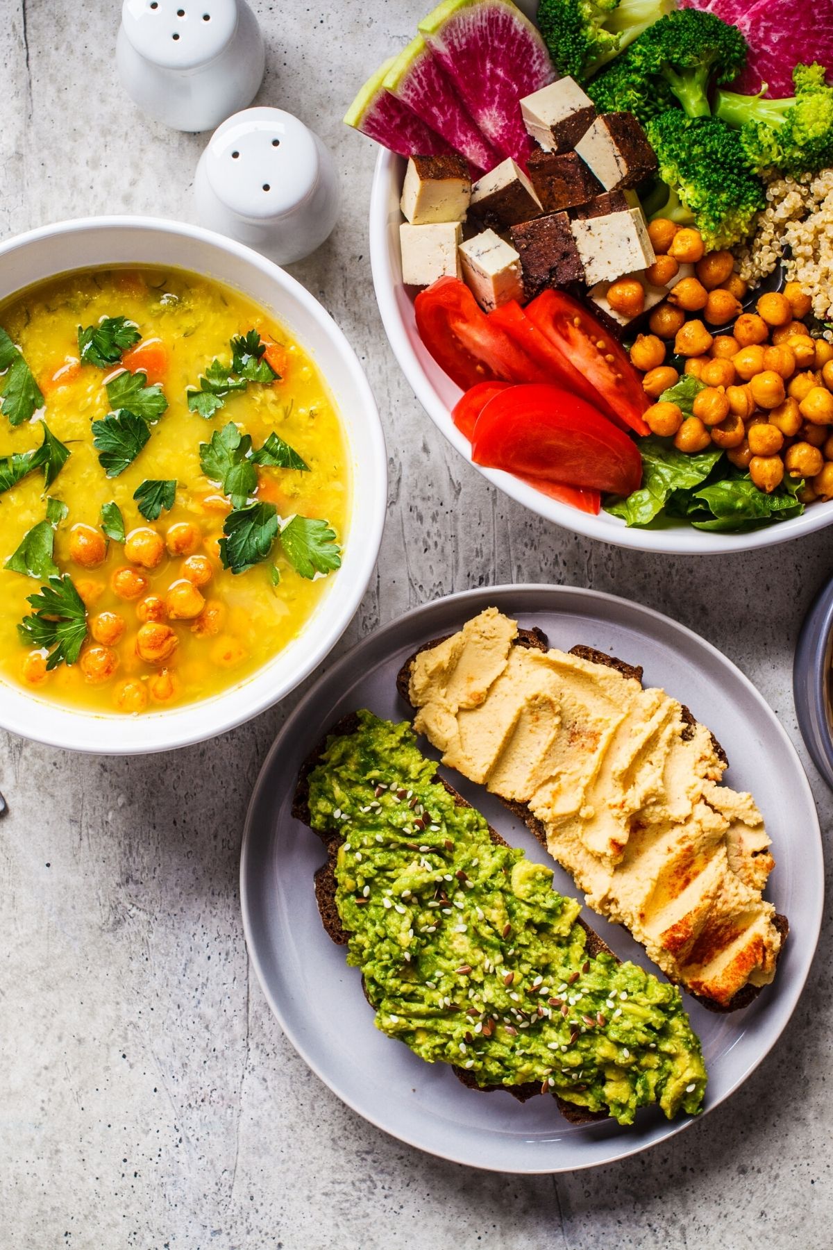 dishes with colorful plant-based meals on a table.