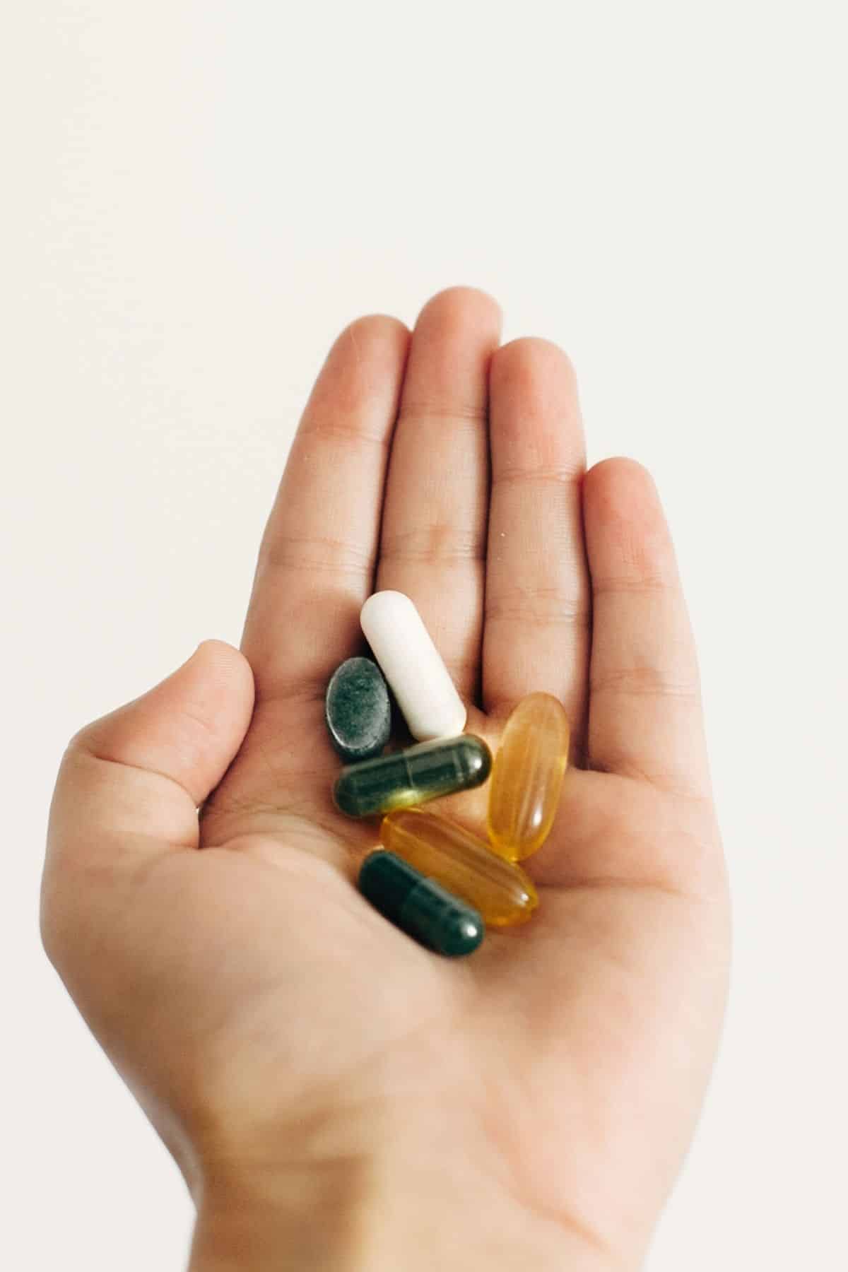 woman holding supplements.