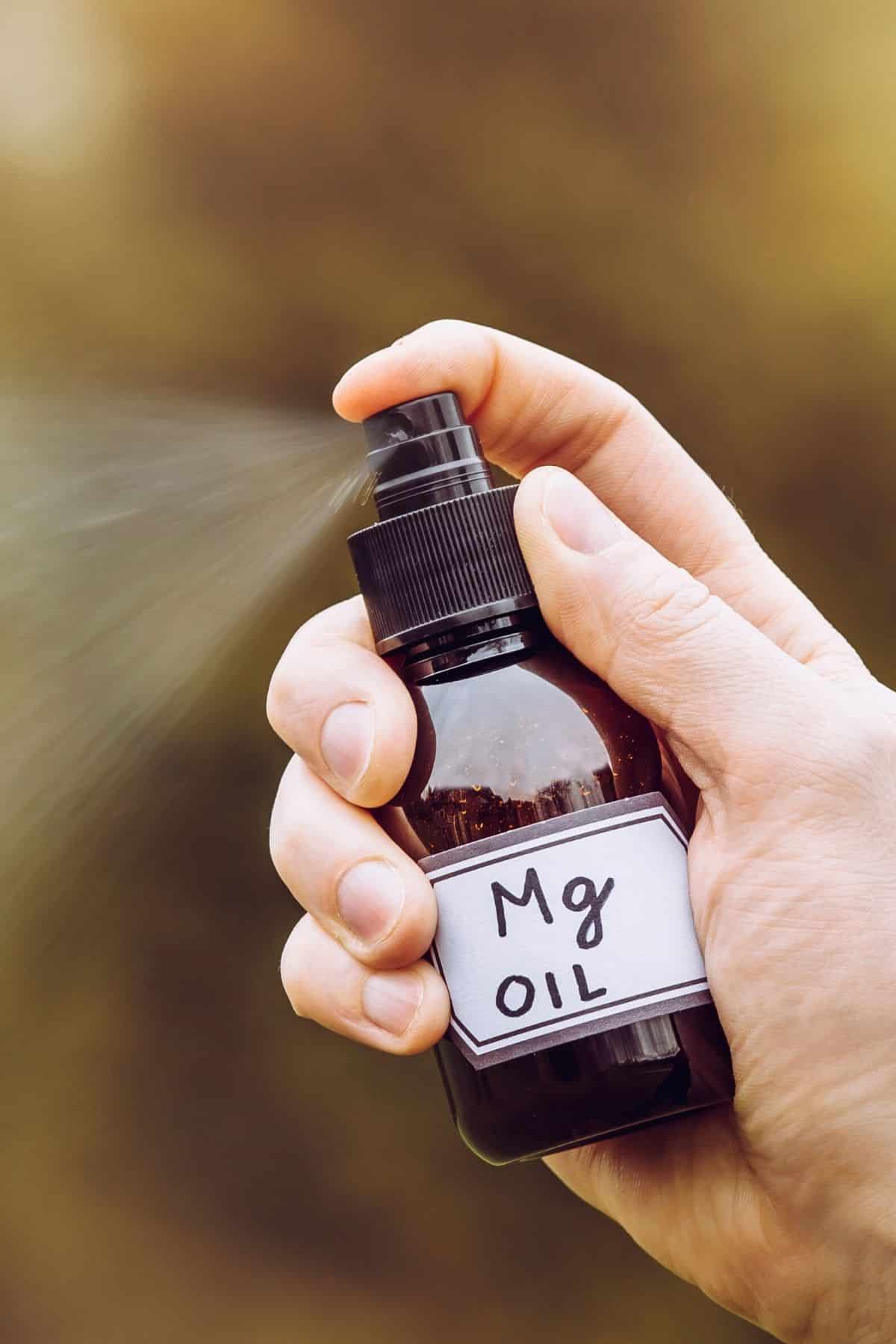 person spraying magnesium oil.