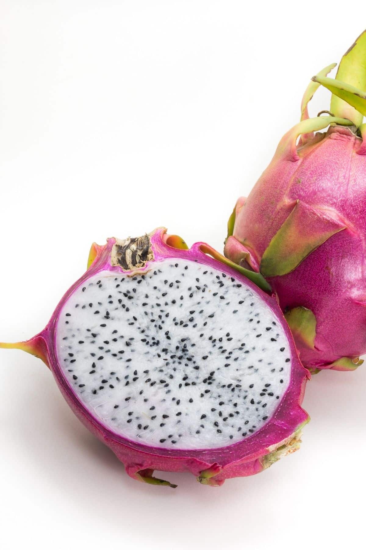 Pink outside with white flesh inside dragonfruit cut in half.
