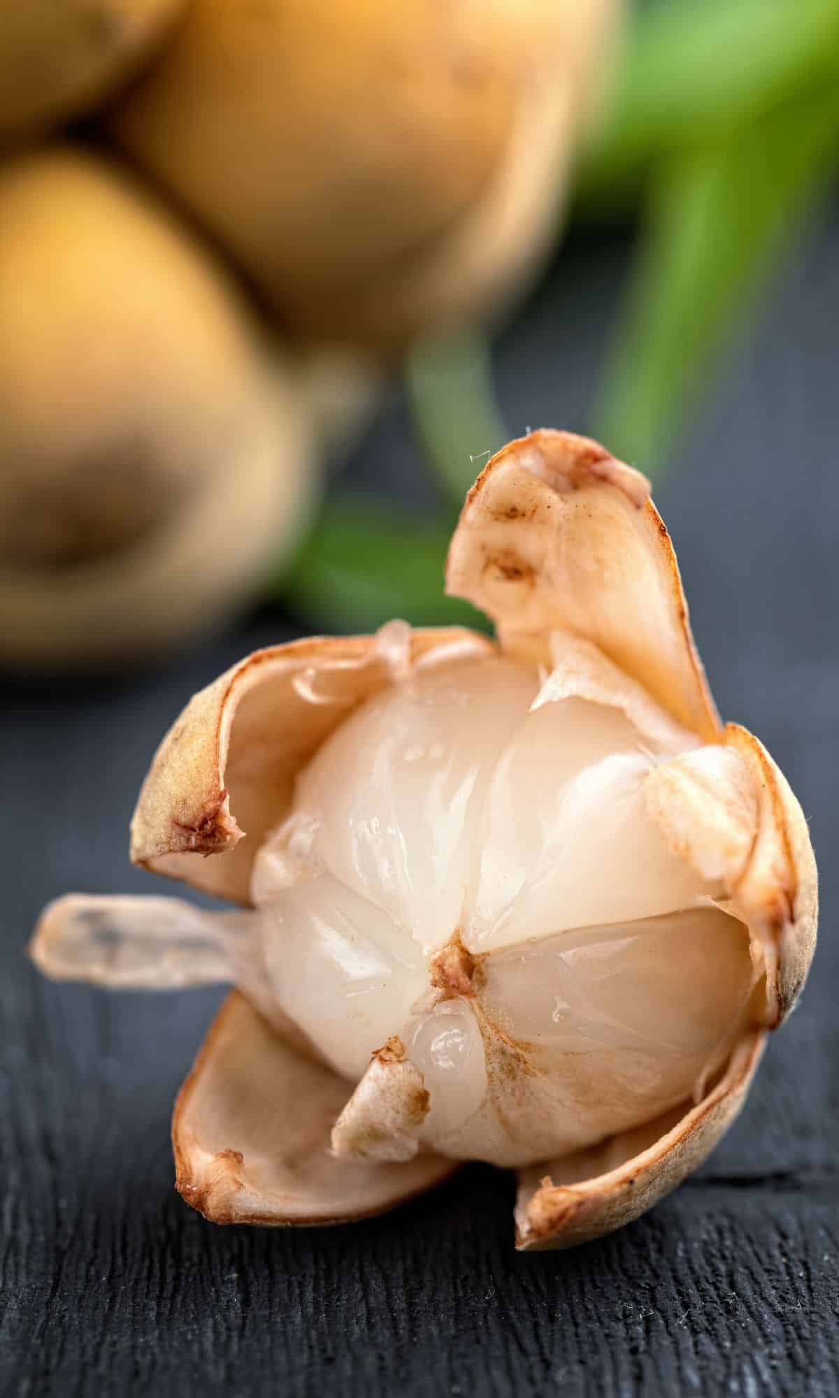 an images of langsat fruit, on a table, peeled.