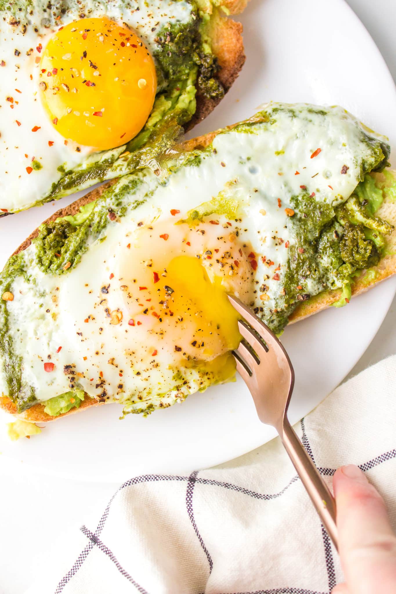 pesto eggs on plate with fork.