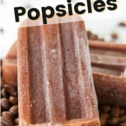 Coffee popsicle on top of coffee beans with text.