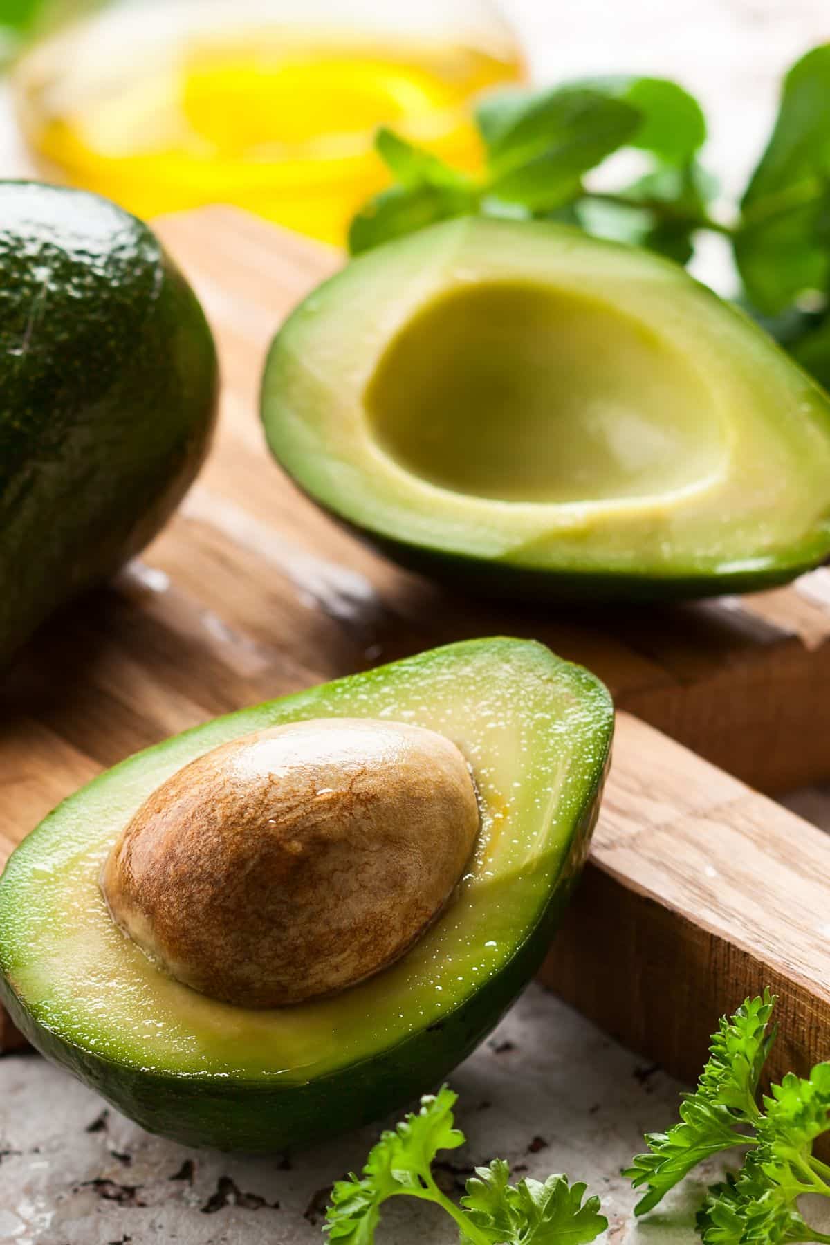 avocado cut in half on table.