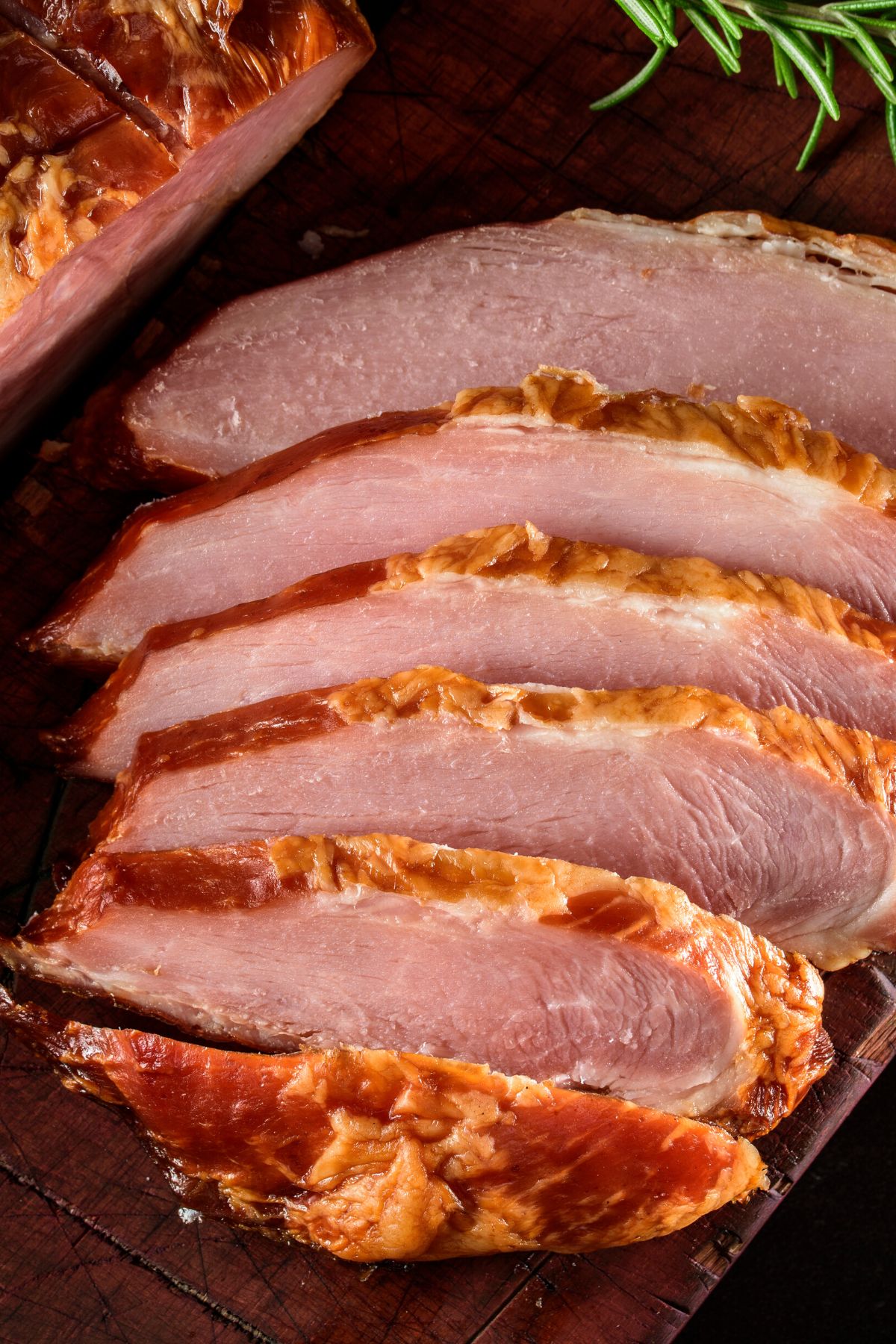 Closeup of slices of baked, glazed ham.