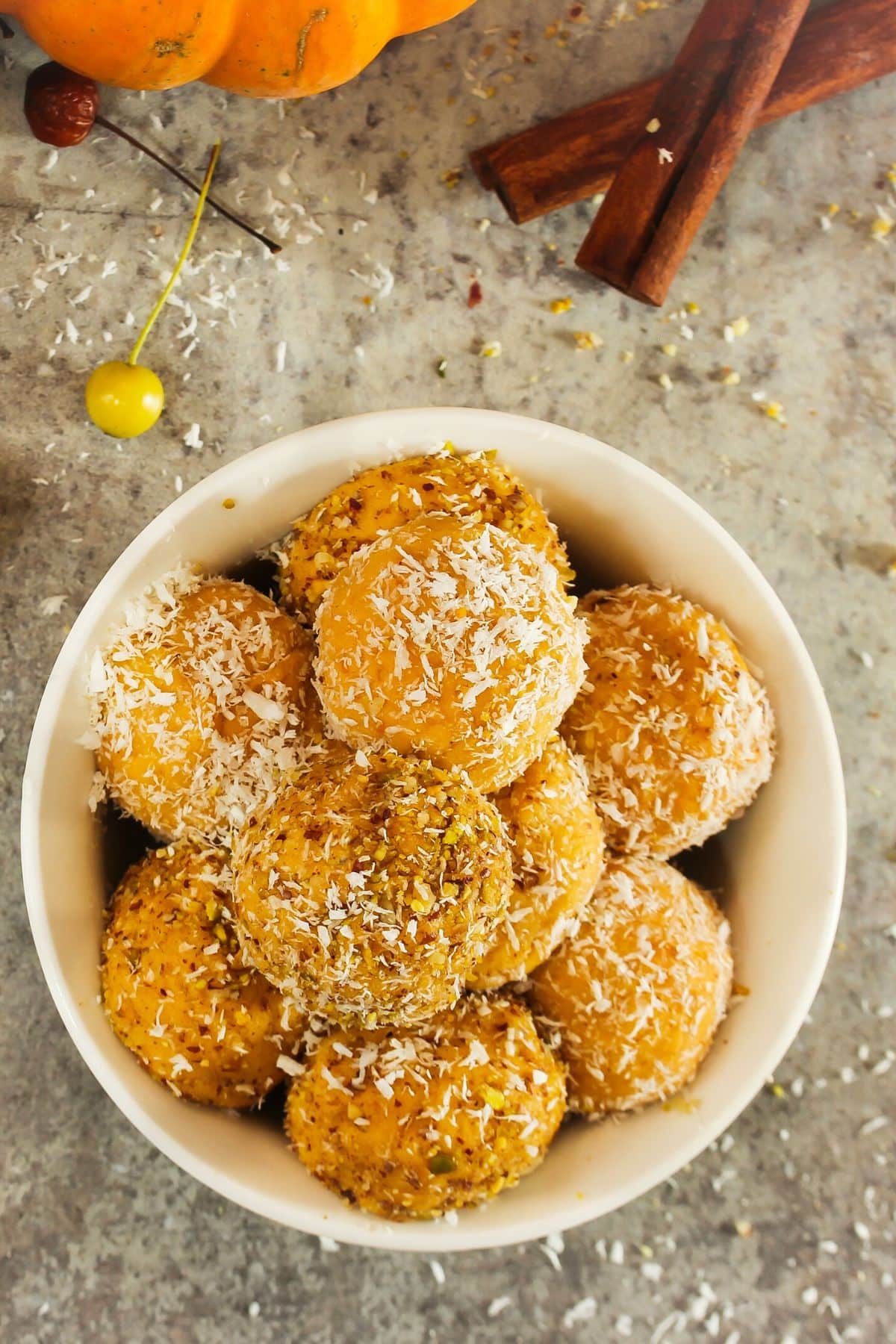 bowl of pumpkin protein balls rolled in shredded coconut. 