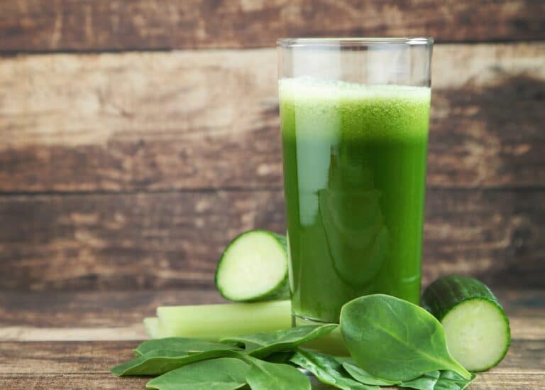 A tall glass of fresh spinach juice.