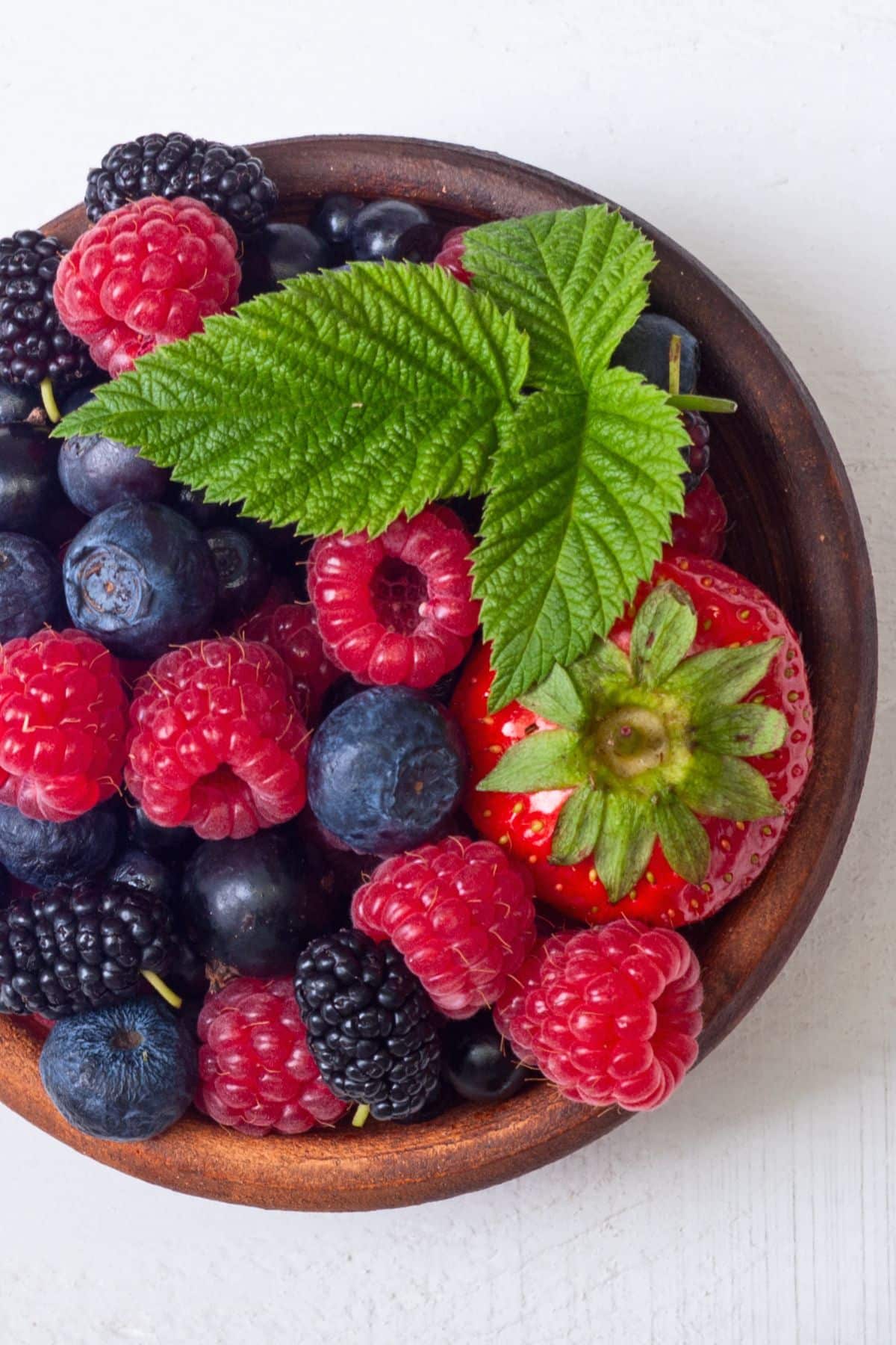 a bowl of blueberries, strawberries, raspberries, and blackberries.