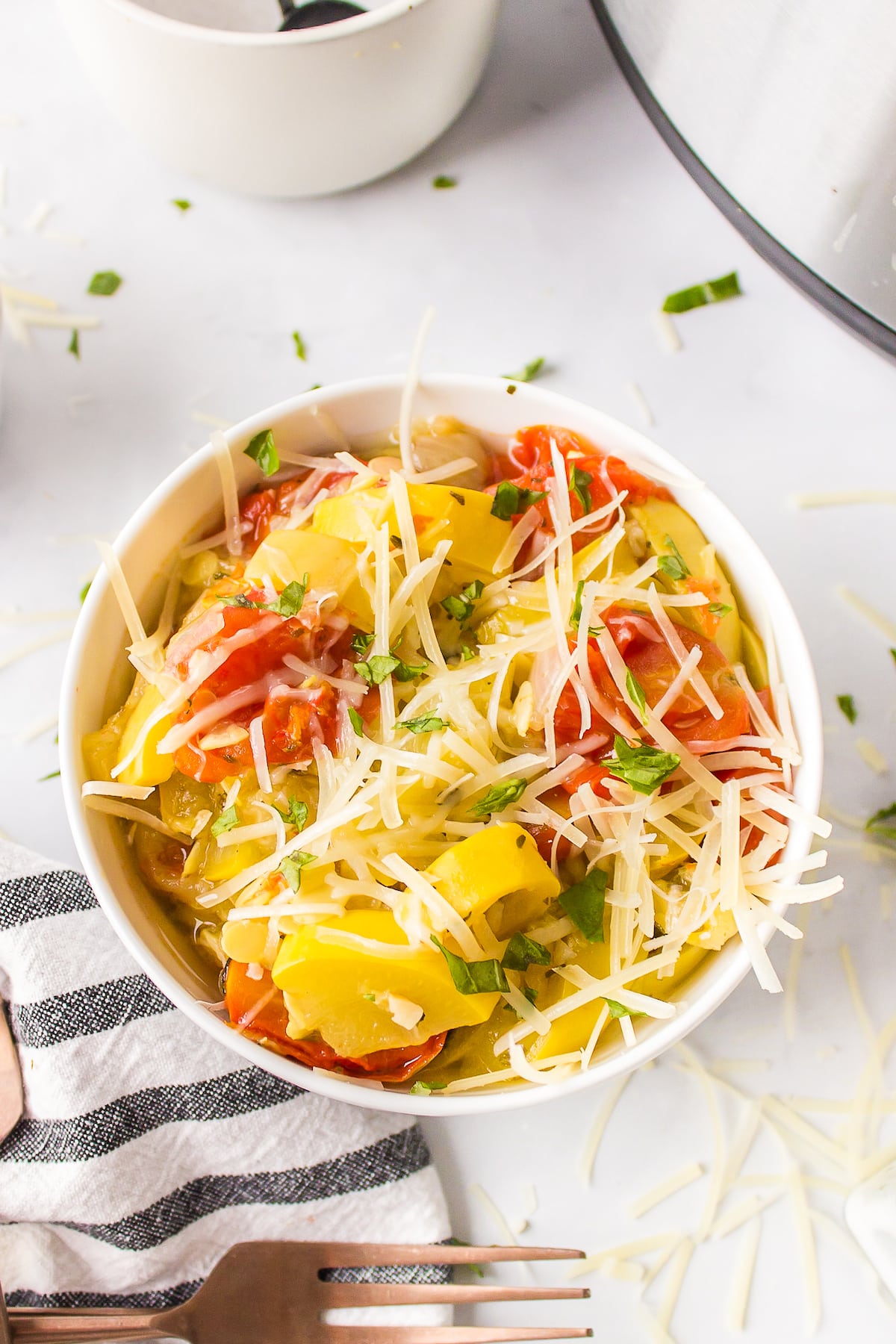 a bowl of instant pot yellow squash and tomatoes.