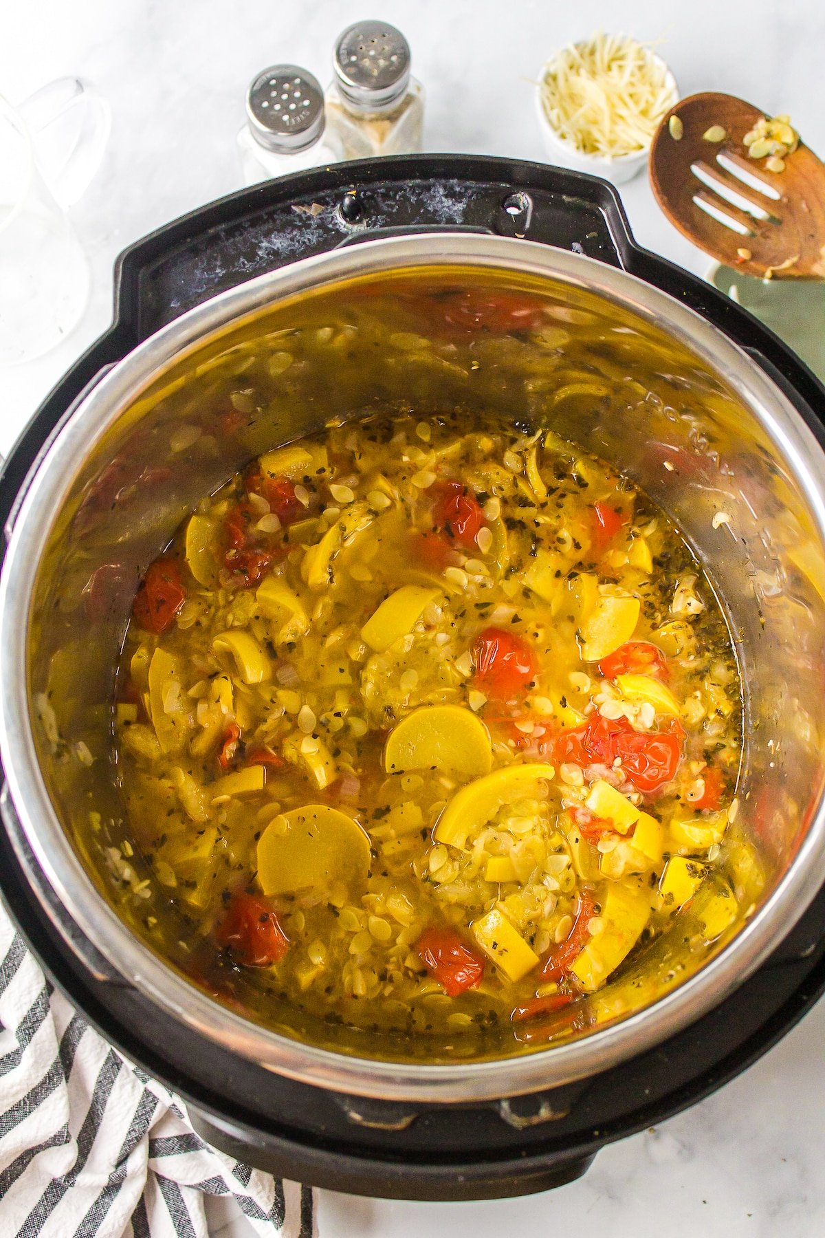 Instant Pot full of yellow squash and tomatoes.