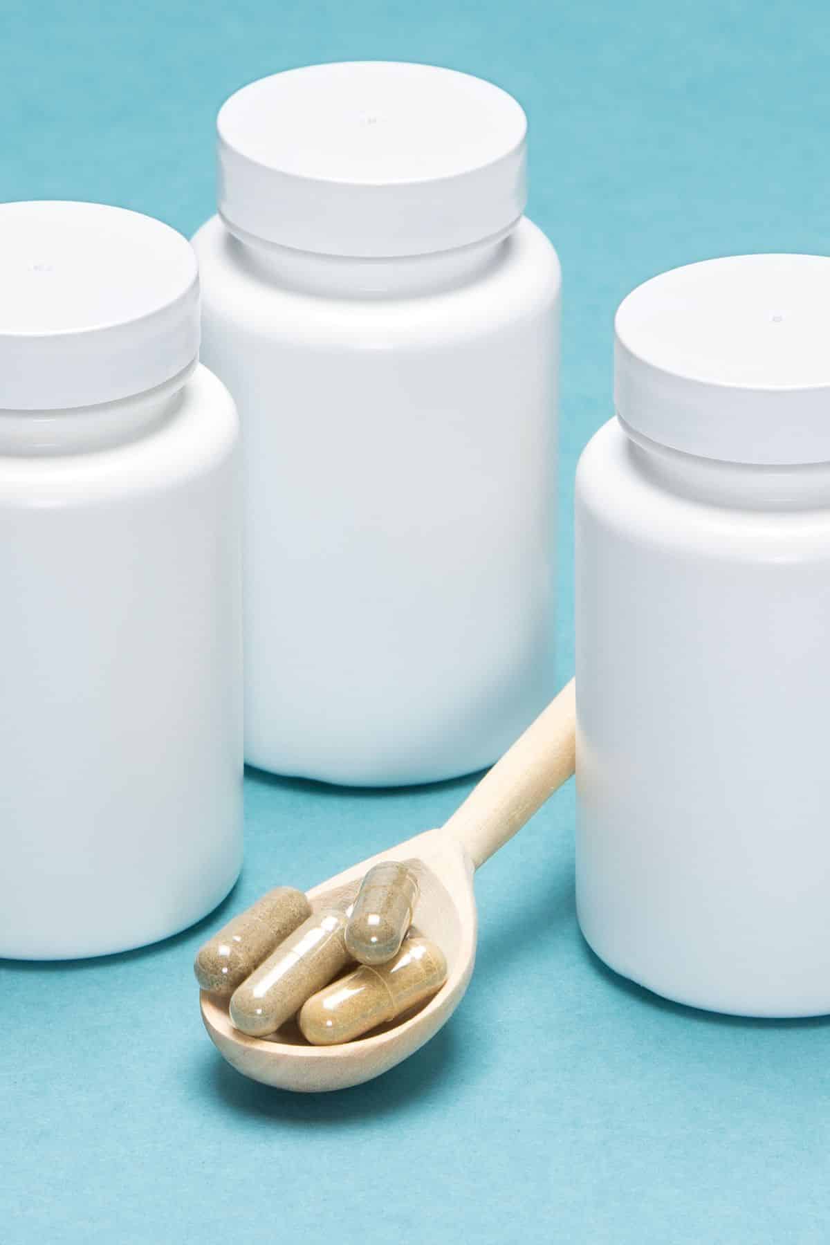 supplement in a spoon on table with containers.