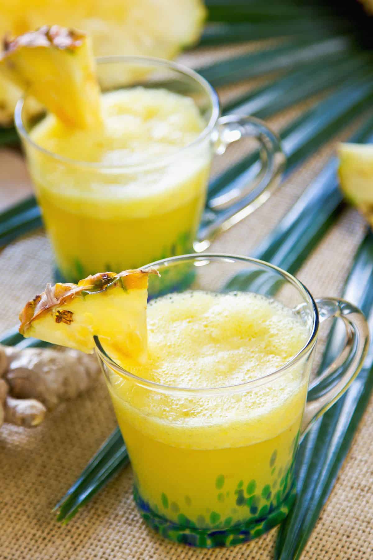 two glasses pineapple ginger juice.